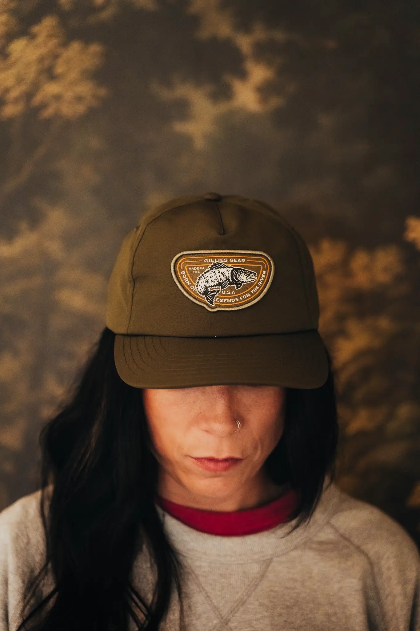 Woman in an olive Gillies patch cap