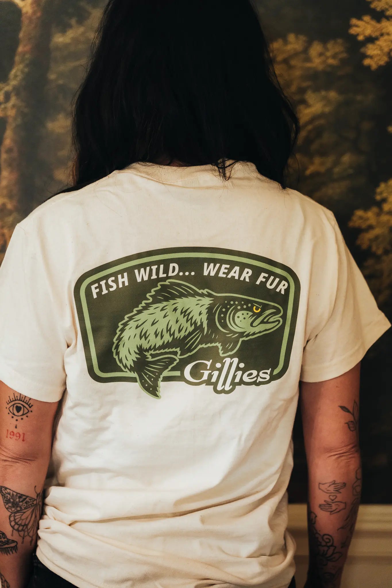 Back of a cream tee reading Fish Wild, Wear Fur, Gillies